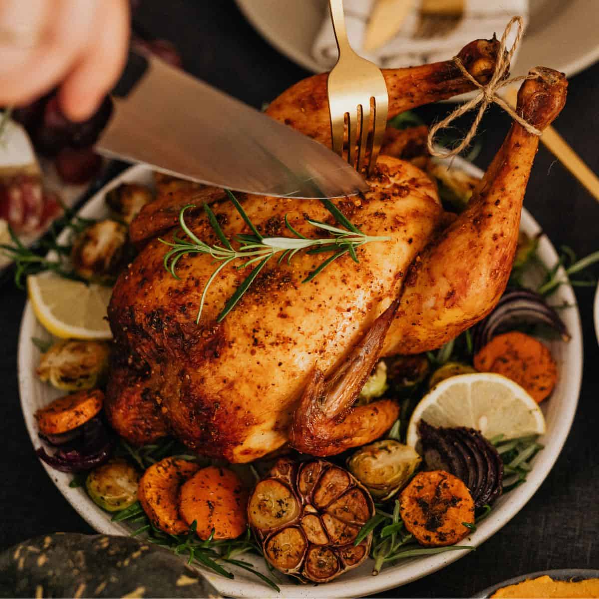 Roast Chicken with herbs and spices in a round baking dish.