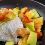 Opo squash with shrimp, onions and tomatoes on a bed of steamed white rice.