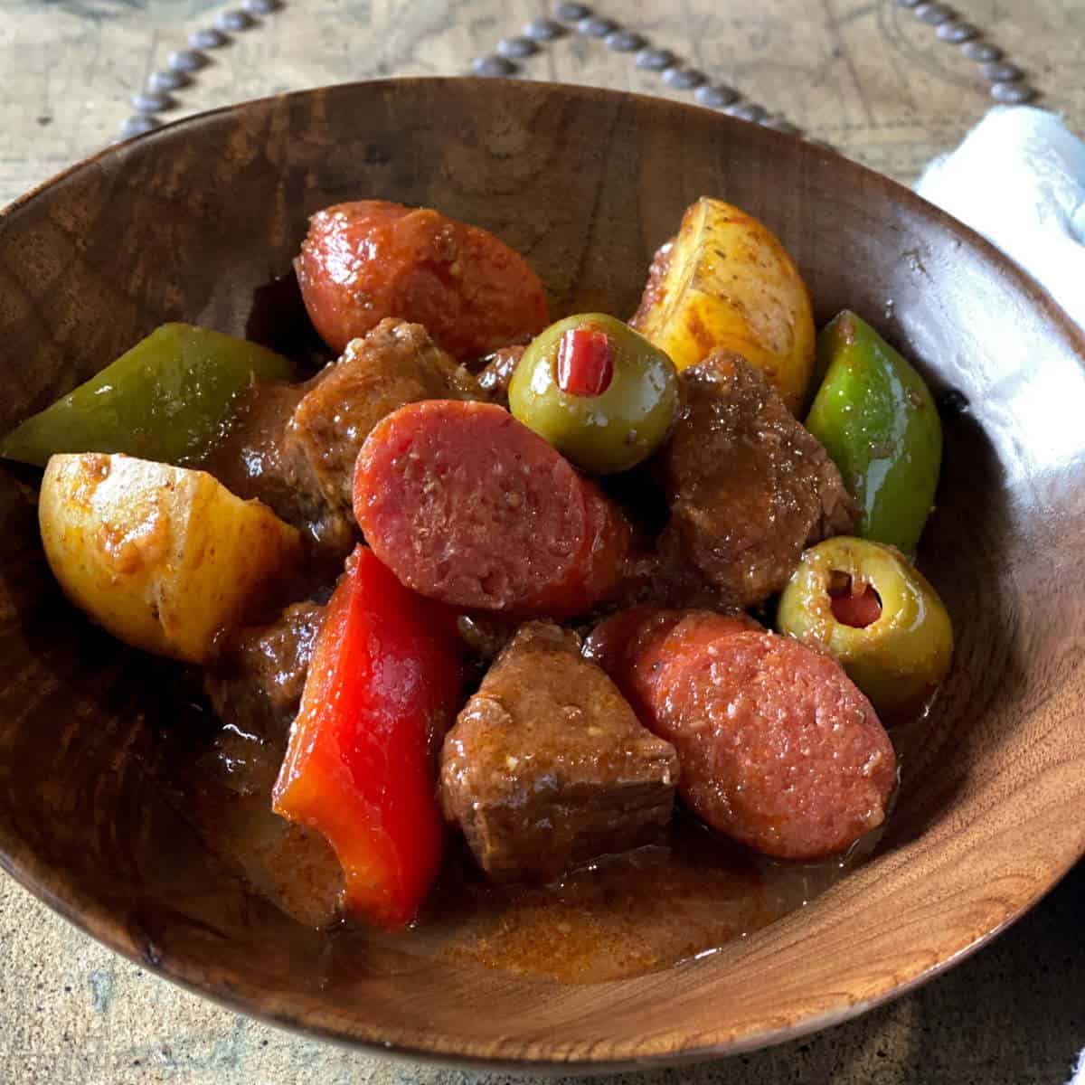 Beef Caldereta on a wooden bowl.