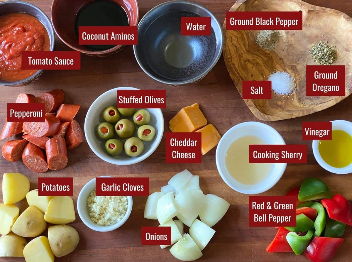 Ingredients for Beef Caldereta on a wooden board.