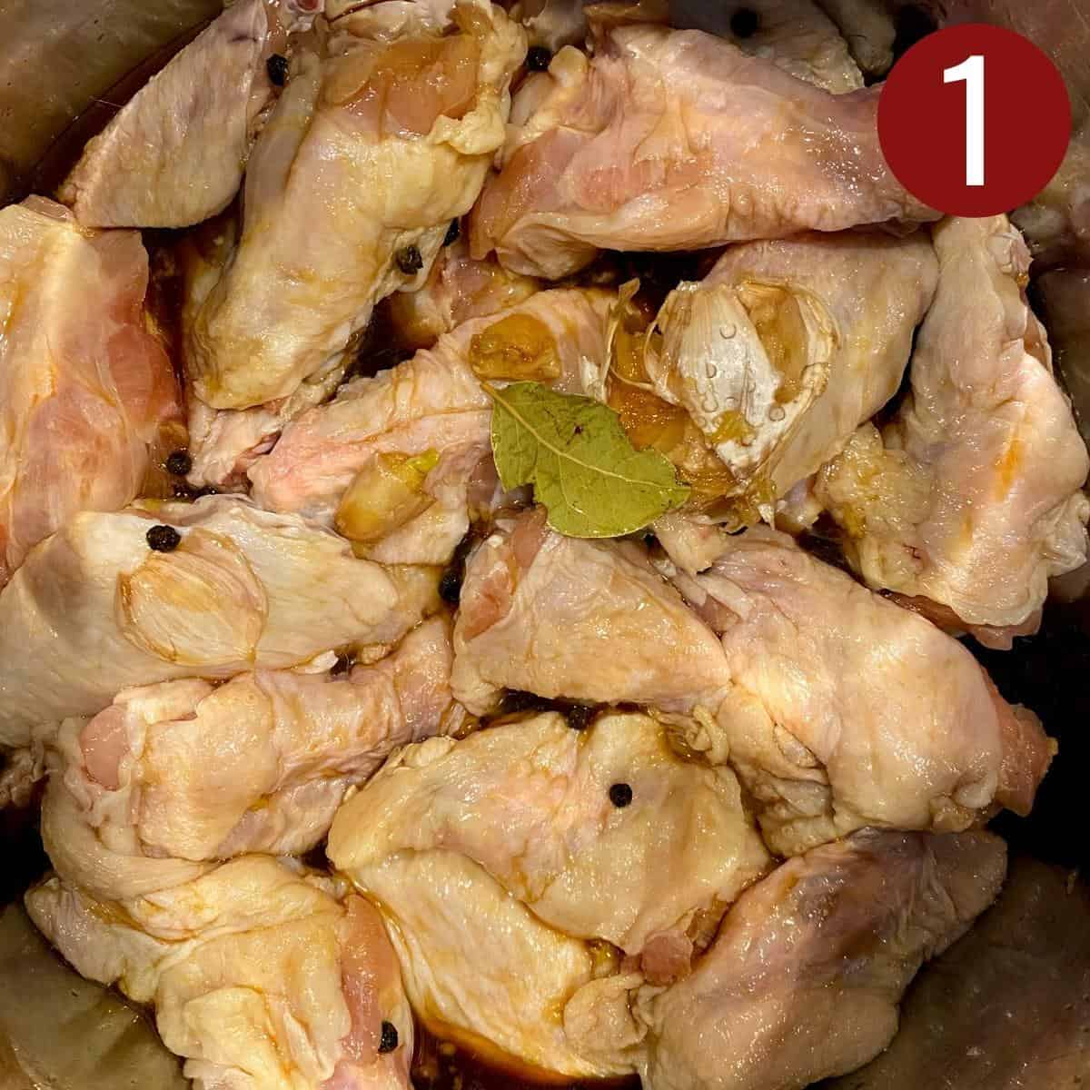 Chicken wings with black peppercorns and dry bay leaf in an instant pot.