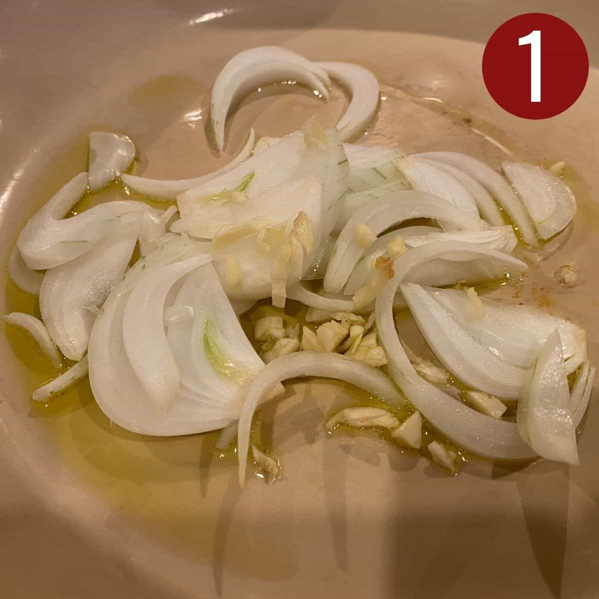 Step 1 add sliced onion and garlic in the skillet with hot oil.