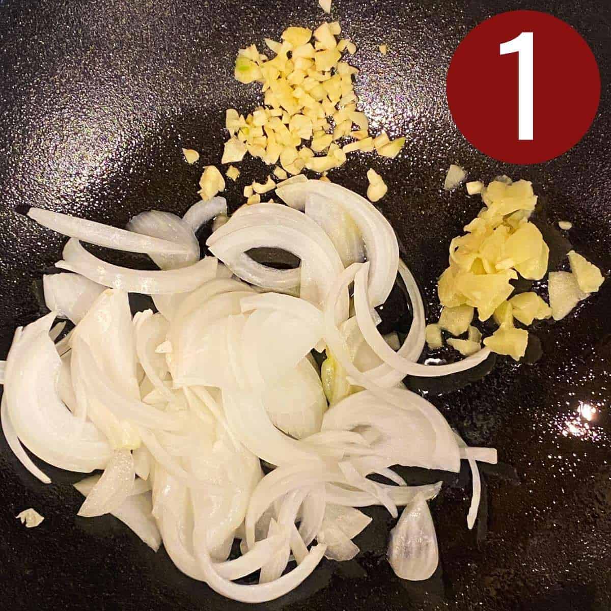 Step 1 garlic, ginger, and sliced onions on a skillet.