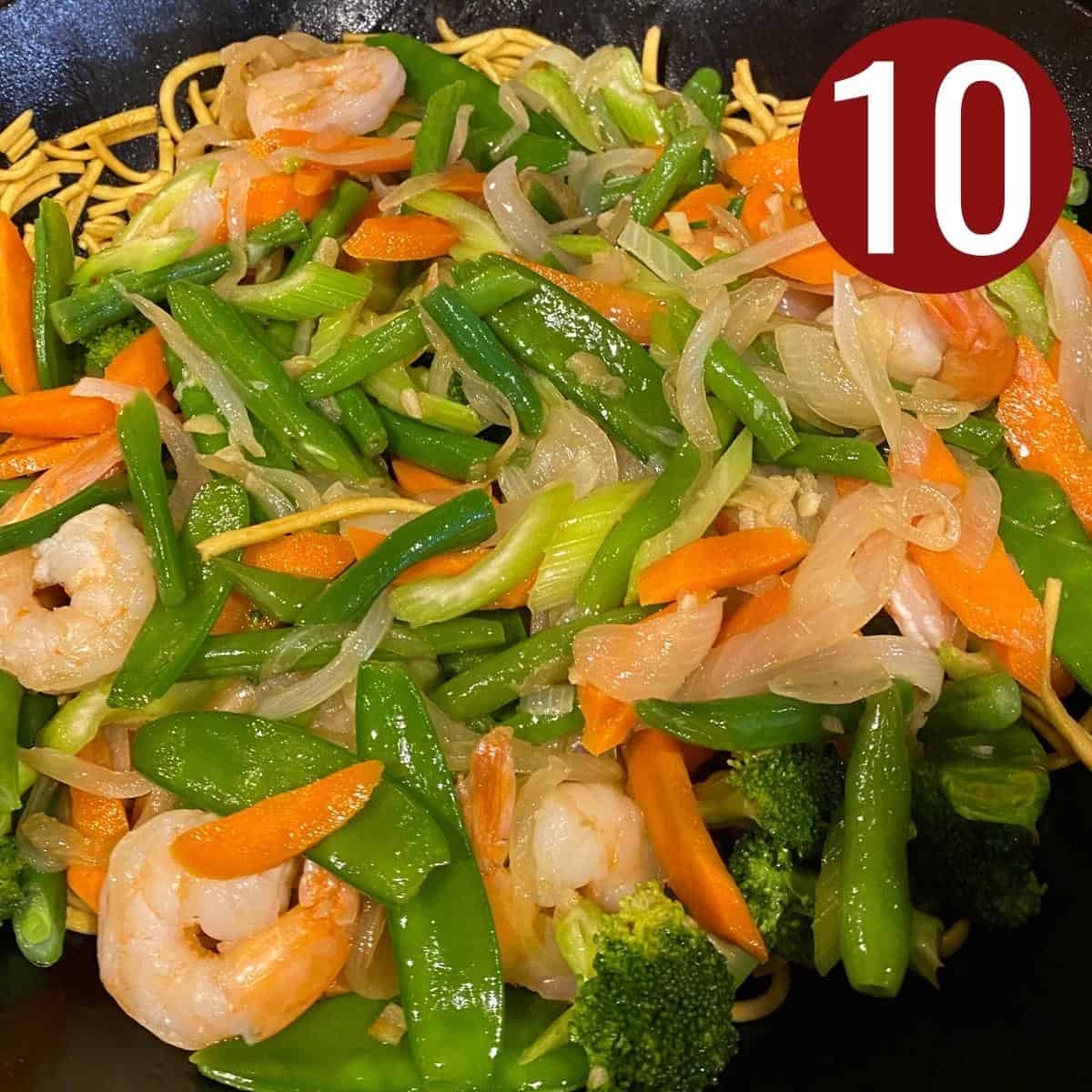 Step 10 cooked shrimp with vegetables for Pancit Canton in a wok.