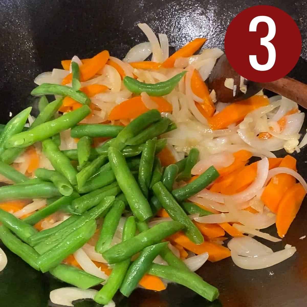 Step 3 green beans, carrots, garlic, ginger, and onions on a skillet.
