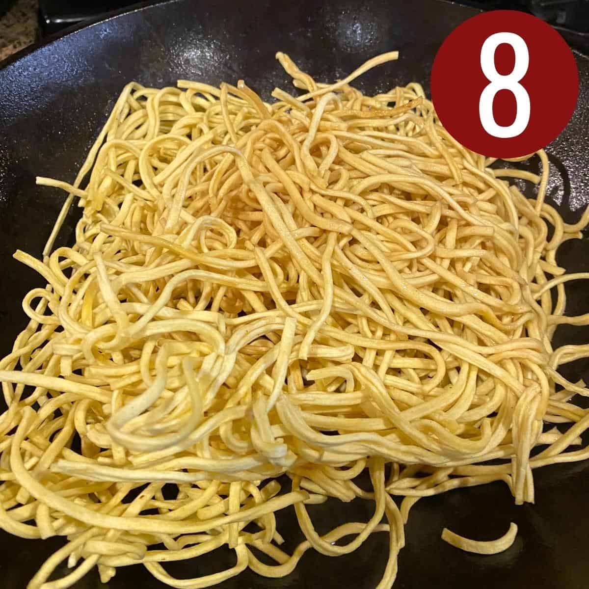 Step 8 pancit canton noodles in a wok.