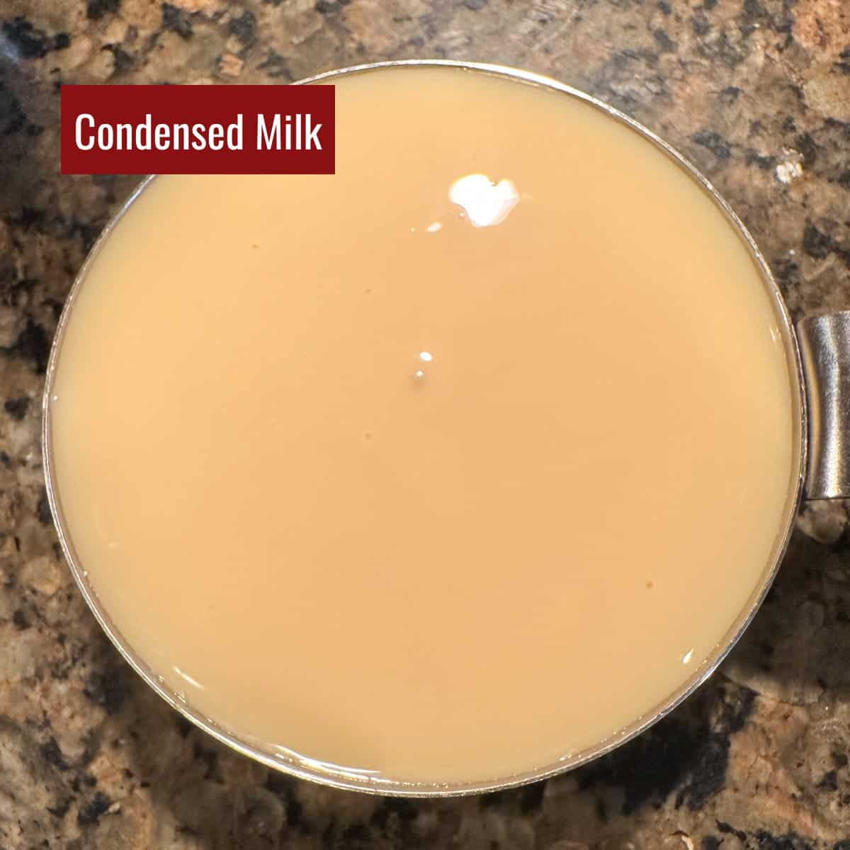 Condensed milk in a measuring cup.