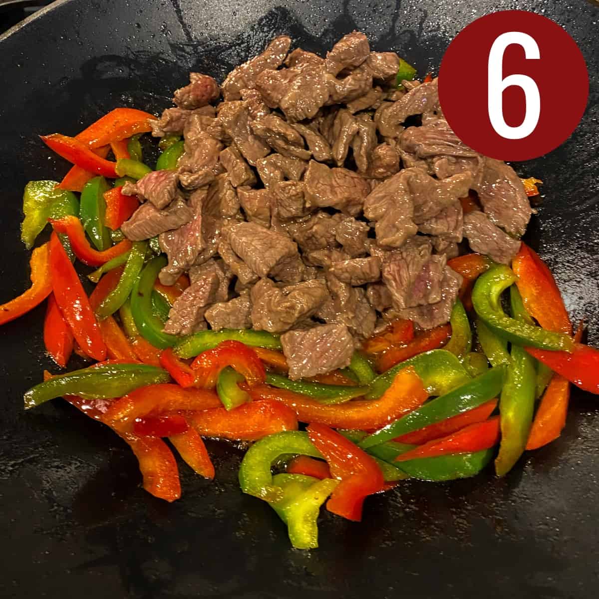 Step 6 sliced beef with red and green bell peppers for stir fry in a skillet.