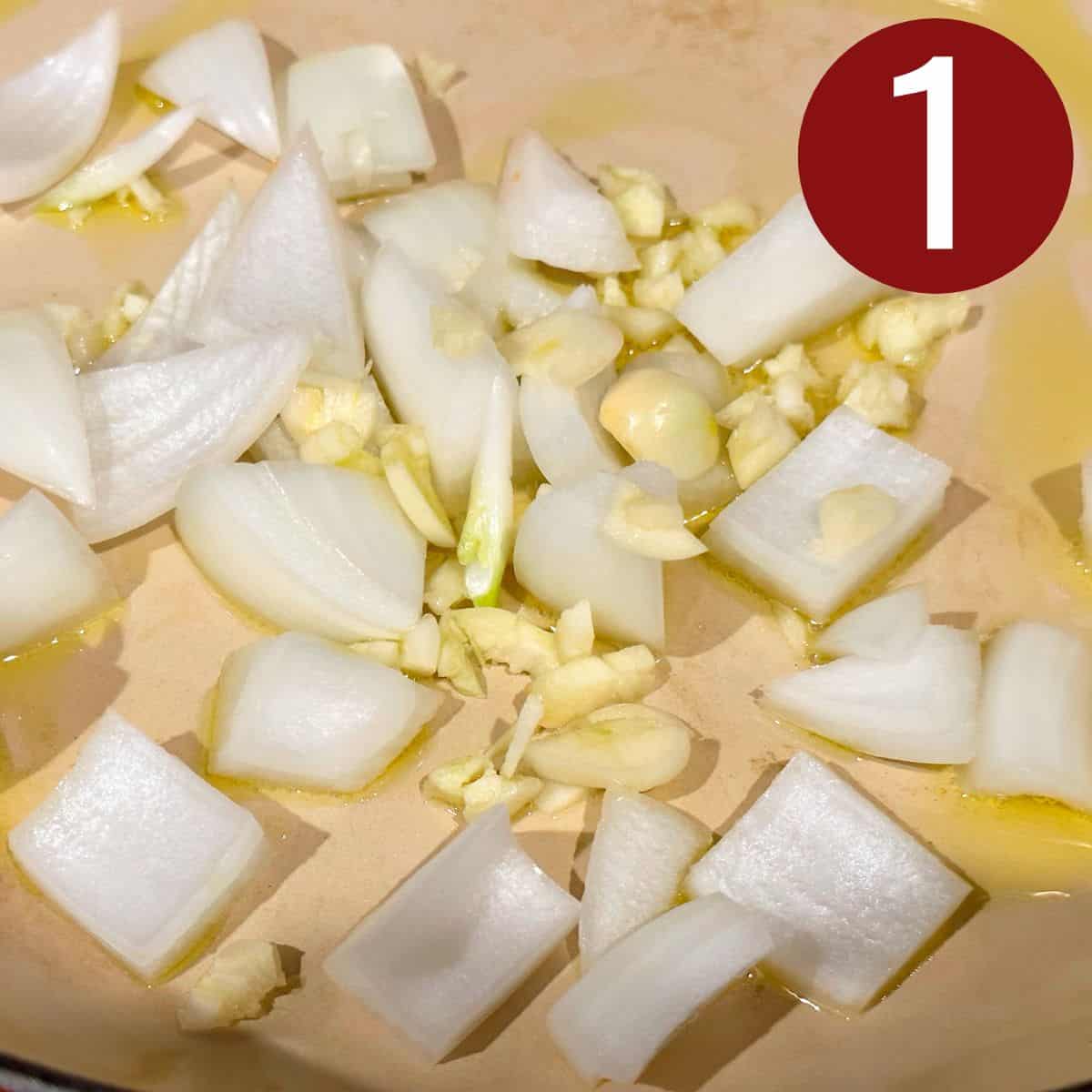 Garlic and sliced onions in a skillet with oil.