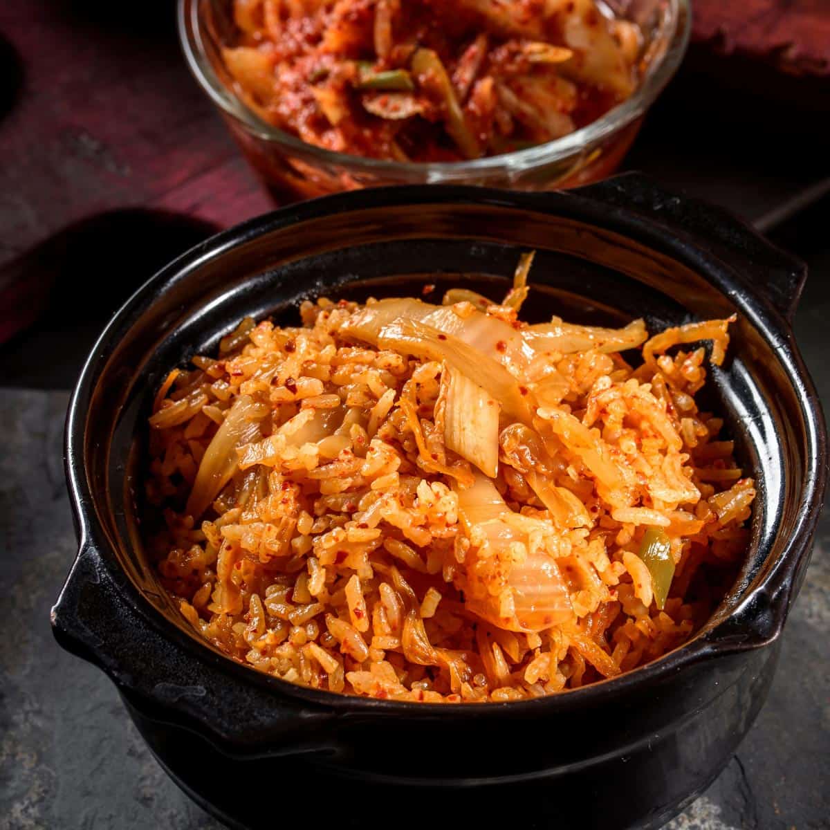 Kimchi fried rice in a black bowl.