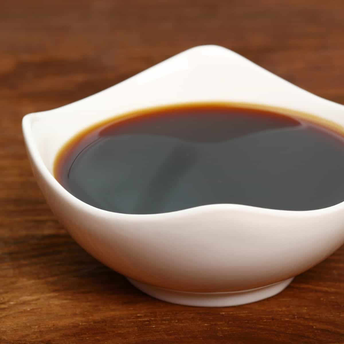 Soy sauce in a white bowl.